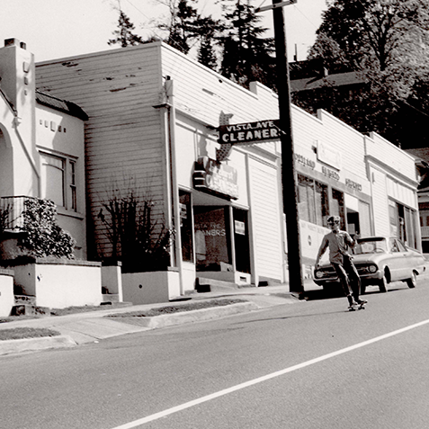 Teenagers skateboarding down a slanted street